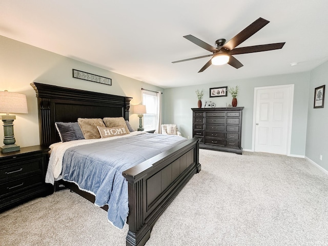 bedroom with light carpet, ceiling fan, and baseboards