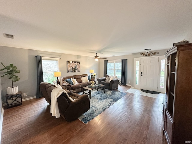 living room featuring ceiling fan and wood-type flooring