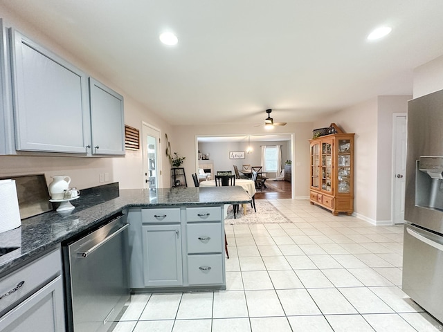 kitchen featuring light tile patterned floors, a ceiling fan, appliances with stainless steel finishes, a peninsula, and recessed lighting