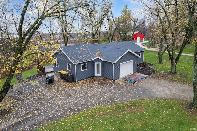 ranch-style house featuring a front lawn and a garage