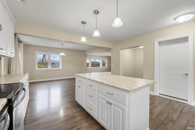 kitchen featuring white cabinets, dark hardwood / wood-style flooring, and hanging light fixtures