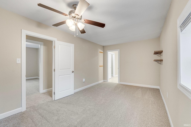 carpeted spare room with ceiling fan