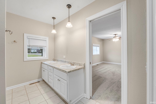 bathroom featuring tile patterned flooring, ceiling fan, and vanity