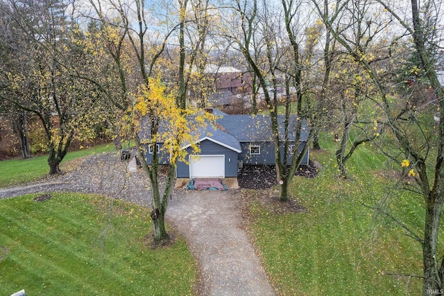 obstructed view of property featuring a garage and a front yard