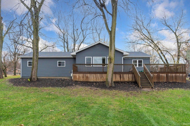 rear view of house featuring a lawn and a deck