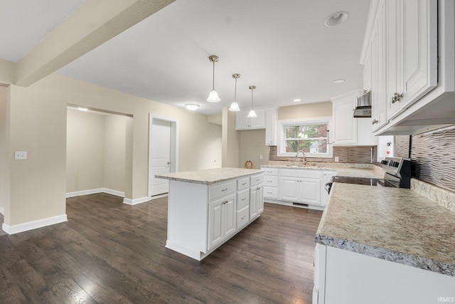 kitchen with white cabinetry, stainless steel range, a kitchen island, and pendant lighting