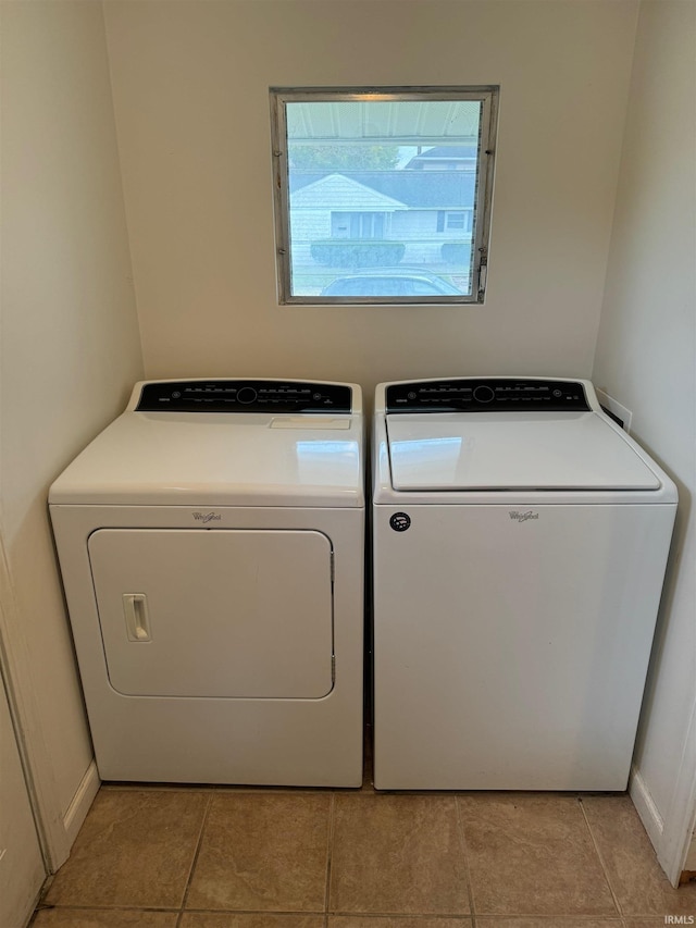 washroom featuring washer and clothes dryer and light tile patterned floors