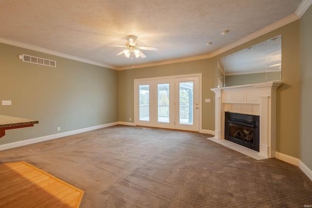 unfurnished living room featuring a fireplace, light carpet, crown molding, and ceiling fan