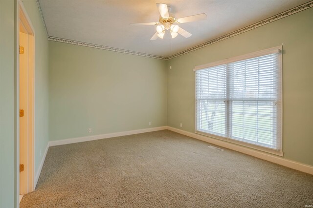 spare room featuring carpet and ceiling fan