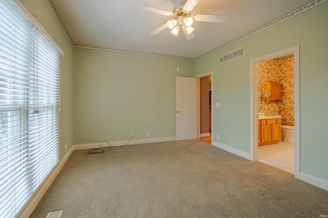 carpeted spare room featuring ceiling fan and ornamental molding