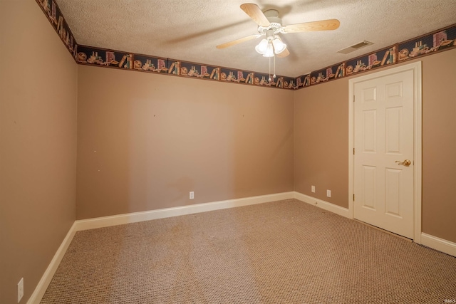 empty room with ceiling fan, carpet, and a textured ceiling