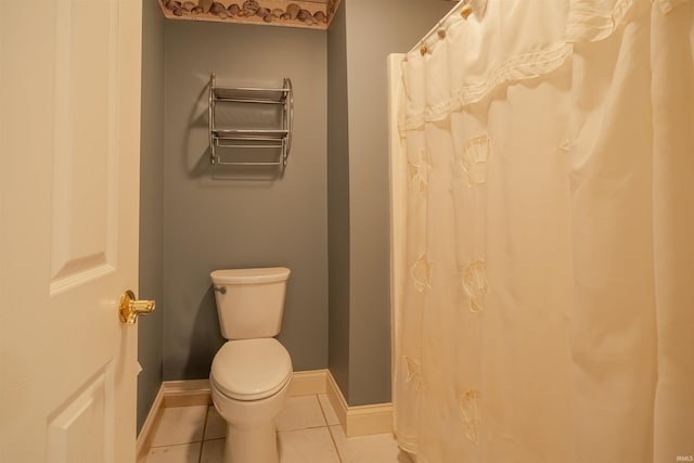 bathroom featuring tile patterned flooring and toilet