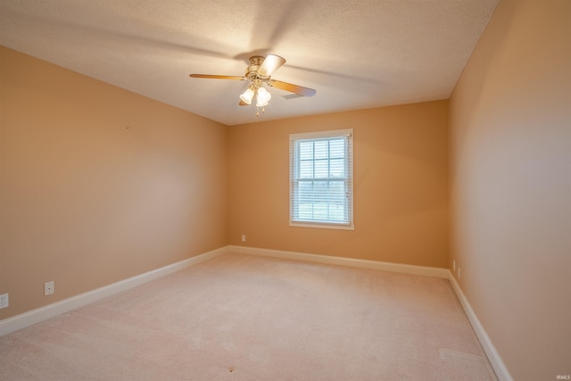 unfurnished room with carpet flooring, ceiling fan, and a textured ceiling