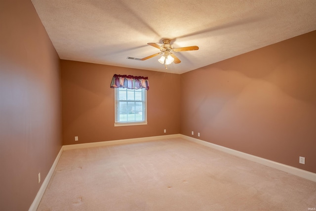 carpeted empty room featuring a textured ceiling and ceiling fan