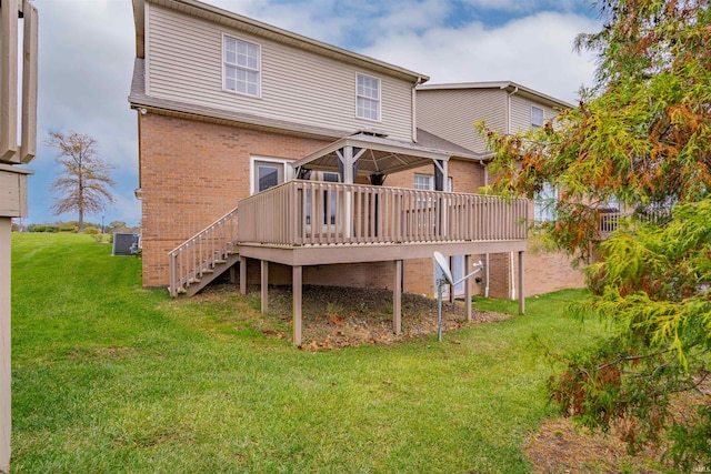 back of property featuring a lawn, a wooden deck, and central AC unit