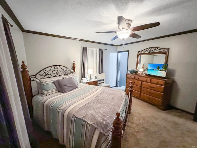 carpeted bedroom with a textured ceiling, ceiling fan, and ornamental molding