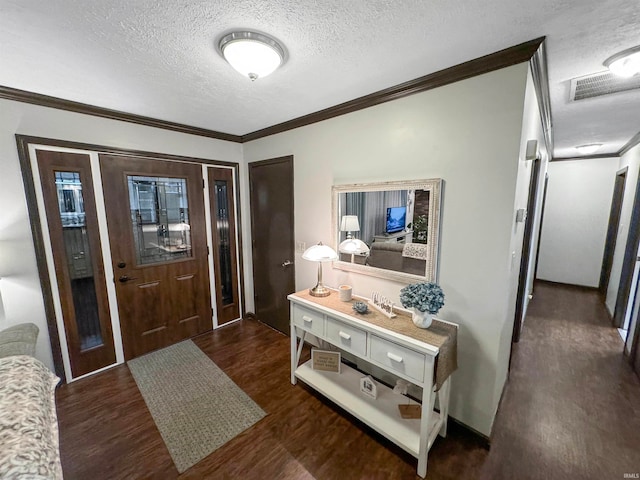 interior space featuring dark wood-type flooring, a textured ceiling, and ornamental molding