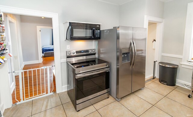 kitchen with stainless steel appliances and light hardwood / wood-style floors