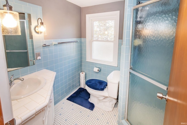 bathroom featuring tile patterned flooring, tile walls, and a shower with shower door