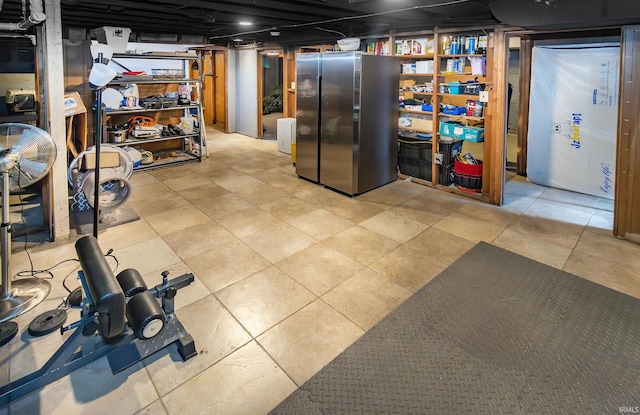 basement with stainless steel refrigerator