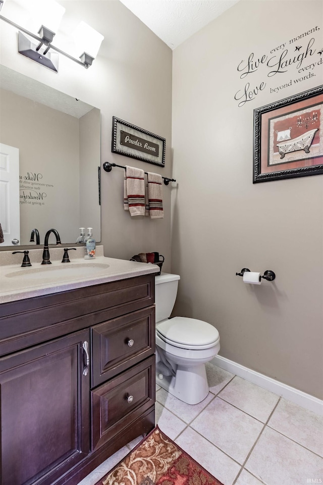 bathroom with tile patterned flooring, vanity, and toilet