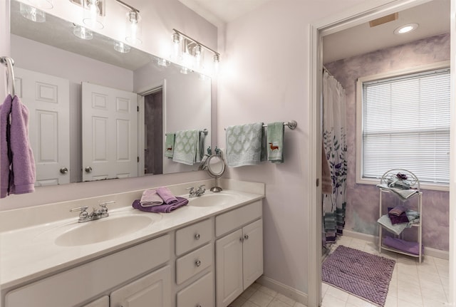 bathroom with tile patterned floors, vanity, and curtained shower