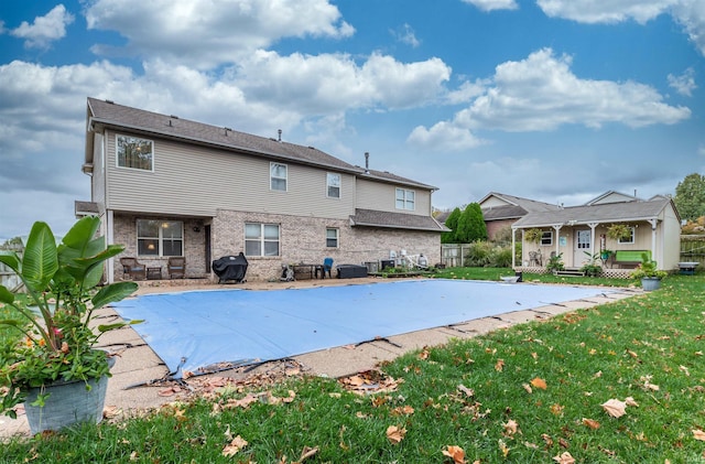 view of swimming pool featuring a lawn, area for grilling, and a patio area