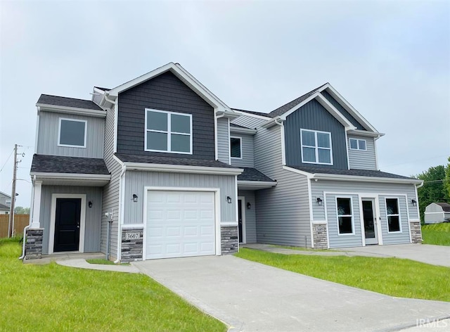 craftsman-style home featuring a front lawn and a garage