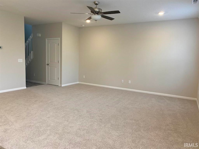 empty room with ceiling fan and light colored carpet