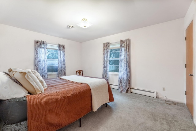 carpeted bedroom with a baseboard radiator