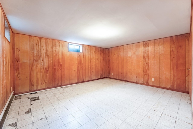 spare room featuring wooden walls