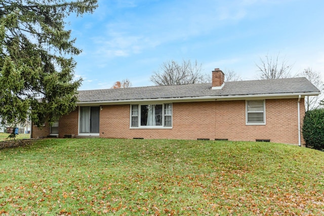 rear view of house with a lawn