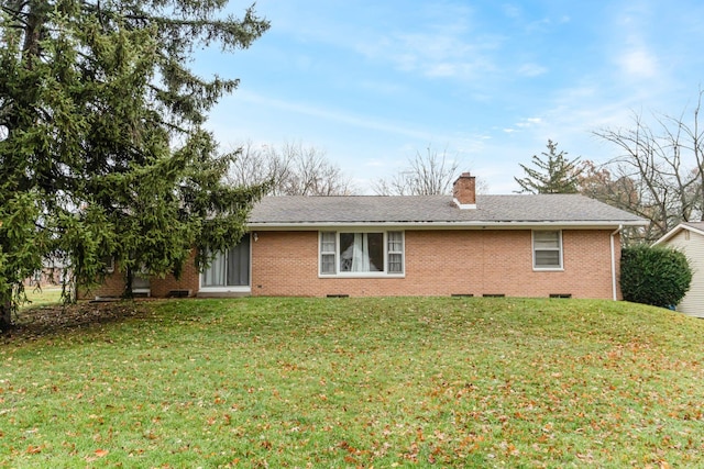 rear view of house featuring a yard