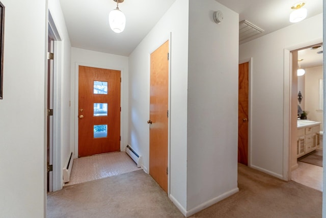 hall with baseboard heating and light colored carpet