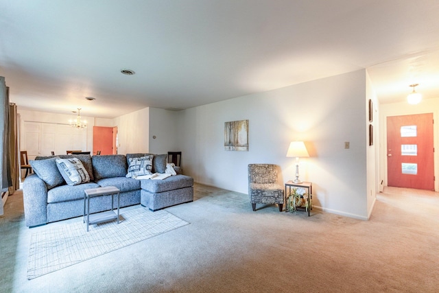 carpeted living room with a notable chandelier