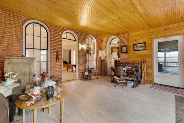205 W Swager Dr, Fremont, IN 46737 - living area featuring hardwood / wood-style flooring, wood ceiling, and brick wall