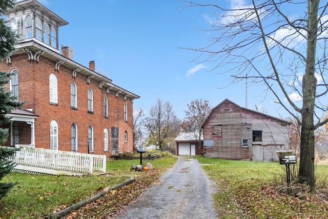 view of home's exterior featuring an outbuilding, a yard, and a garage