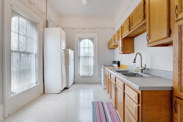 205 W Swager Dr, Fremont, IN 46737 - kitchen with white appliances, light countertops, light floors, and brown cabinets