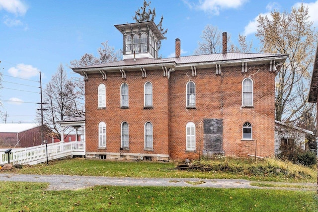 205 W Swager Dr, Fremont, IN 46737 - view of front of house with brick siding, a metal roof, and a chimney