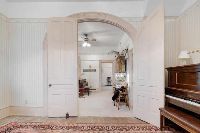 205 W Swager Dr, Fremont, IN 46737 - foyer entrance with wallpapered walls, a ceiling fan, arched walkways, and a baseboard heating unit
