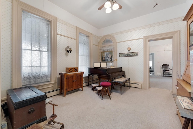 miscellaneous room featuring baseboard heating, ceiling fan, and light colored carpet