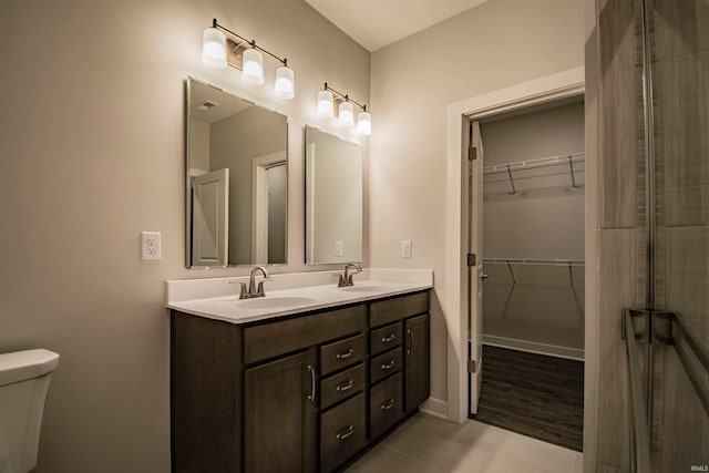 bathroom with tile patterned flooring, vanity, and toilet