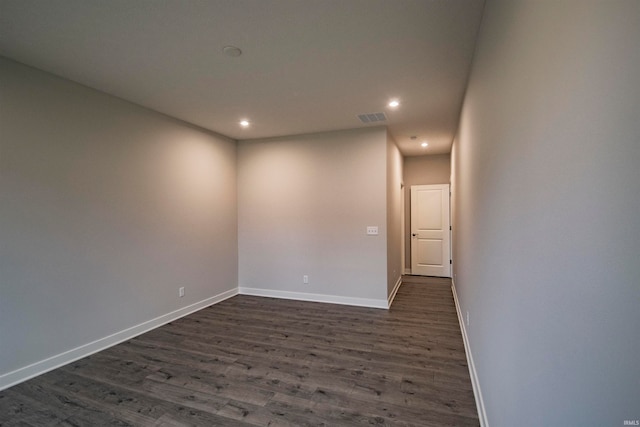 unfurnished room with dark wood-type flooring