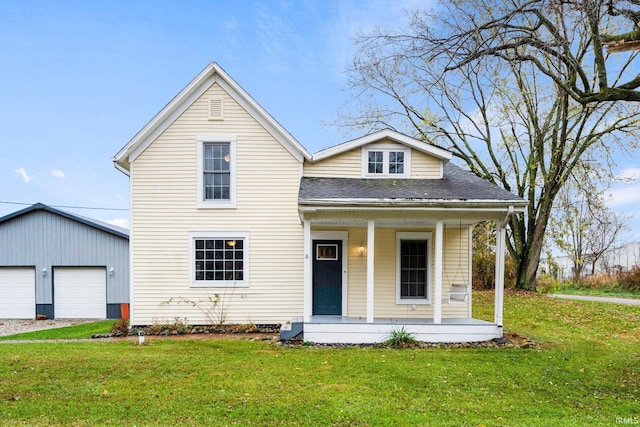 view of front of house featuring a porch, a front yard, an outdoor structure, and a garage