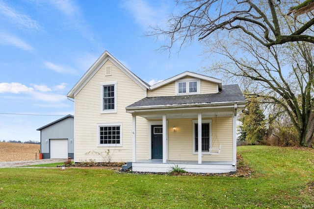 view of front of home featuring a porch, a garage, and a front lawn