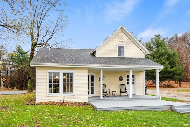 back of house with a lawn and covered porch