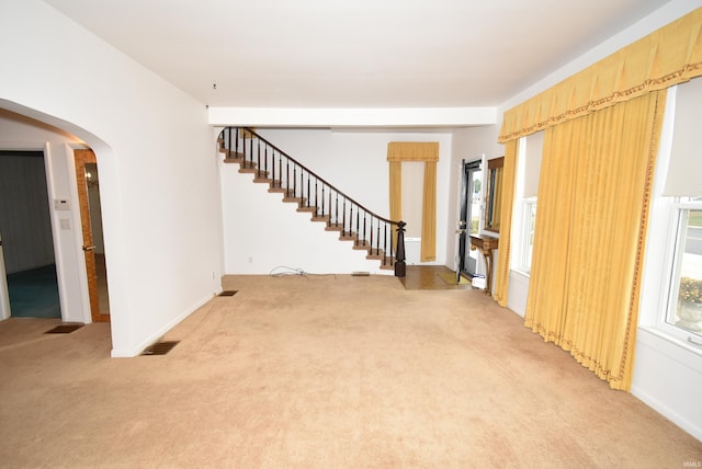 unfurnished living room featuring carpet