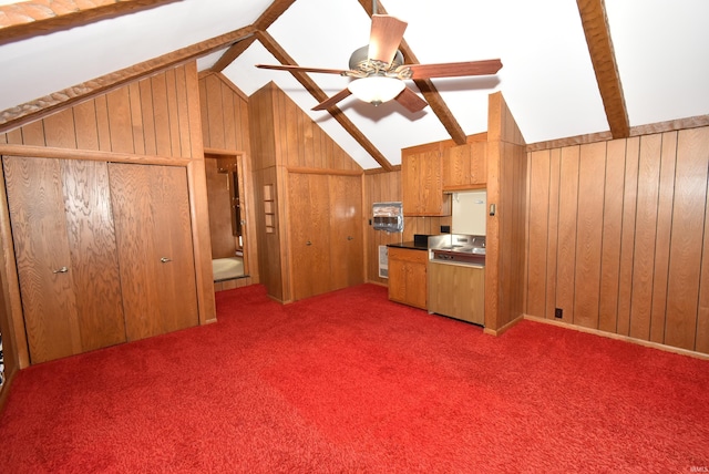 kitchen with carpet, ceiling fan, lofted ceiling with beams, and wooden walls