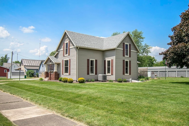 view of front of home with a front lawn and central AC unit