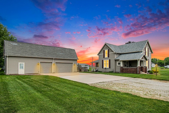 view of front facade with a yard and a garage